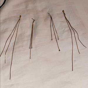 Gold long earrings with diamonds.